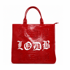 Vibrant red vegan alligator leather utility bag with raised white Gothic text