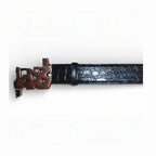 Close-up of black snakeskin finish belt showing copper-toned abstract buckle detail